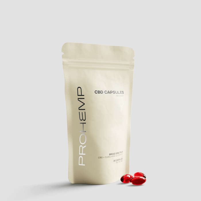 CBD capsules recovery supplement pouch with red softgel capsules on white background
