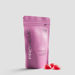 Pink pouch of Calm Gummies with strawberry flavor and three red gummies on white background