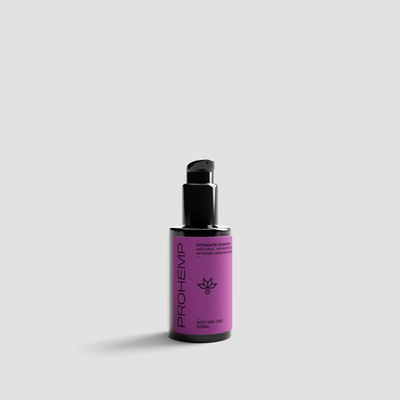 Purple bottle of CBD intimate gel with pump dispenser on light background