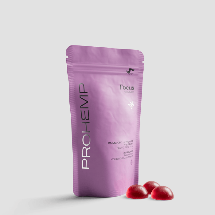 Purple pouch of CBD Focus gummies with three red supplement gummies on a light background